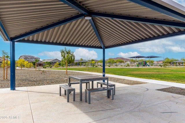 view of property's community with a residential view, a lawn, a patio area, and playground community