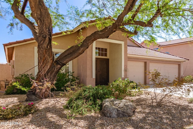 1631 E Carla Vista Dr, Chandler, AZ 85225 - view of front of house with stucco siding, a tiled roof, and an attached garage