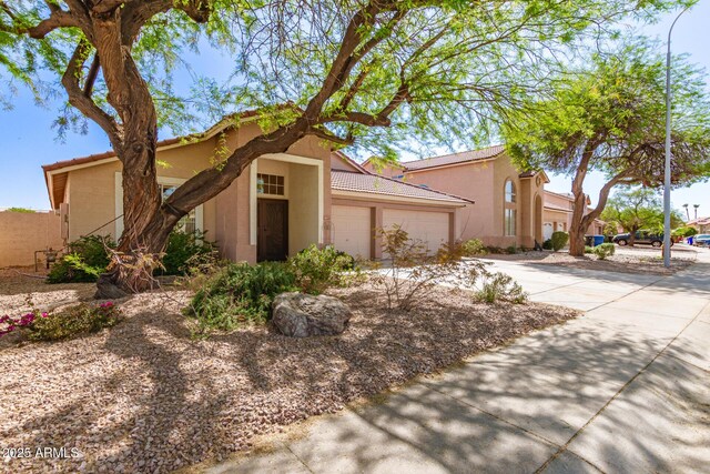 1631 E Carla Vista Dr, Chandler, AZ 85225 - view of front of property featuring concrete driveway, an attached garage, a tile roof, and stucco siding