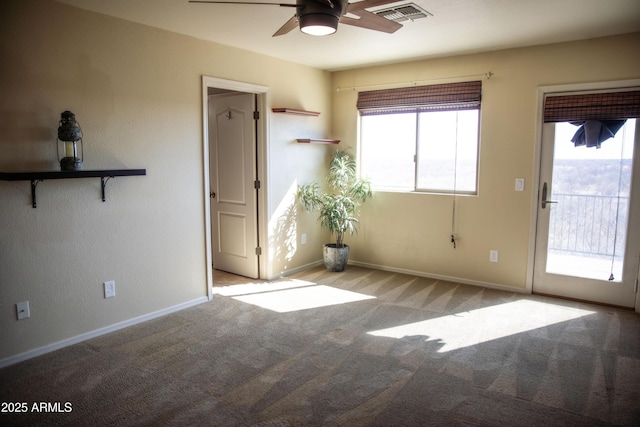 interior space featuring ceiling fan and light colored carpet