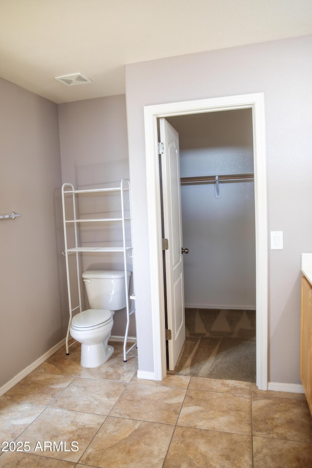 bathroom featuring tile patterned floors, vanity, and toilet