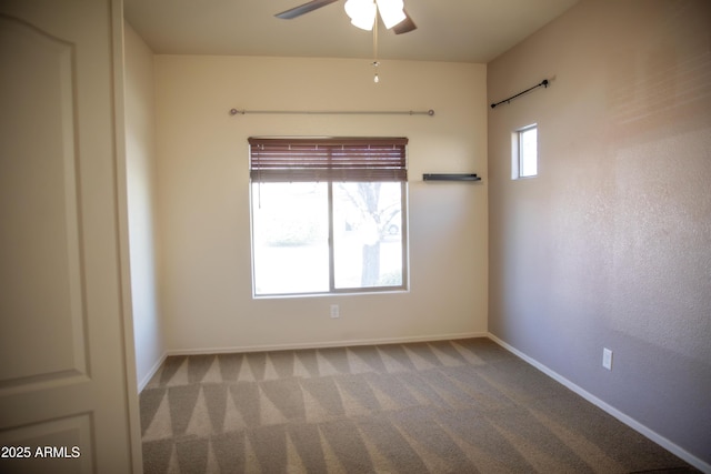 unfurnished room with a wealth of natural light, ceiling fan, and carpet flooring