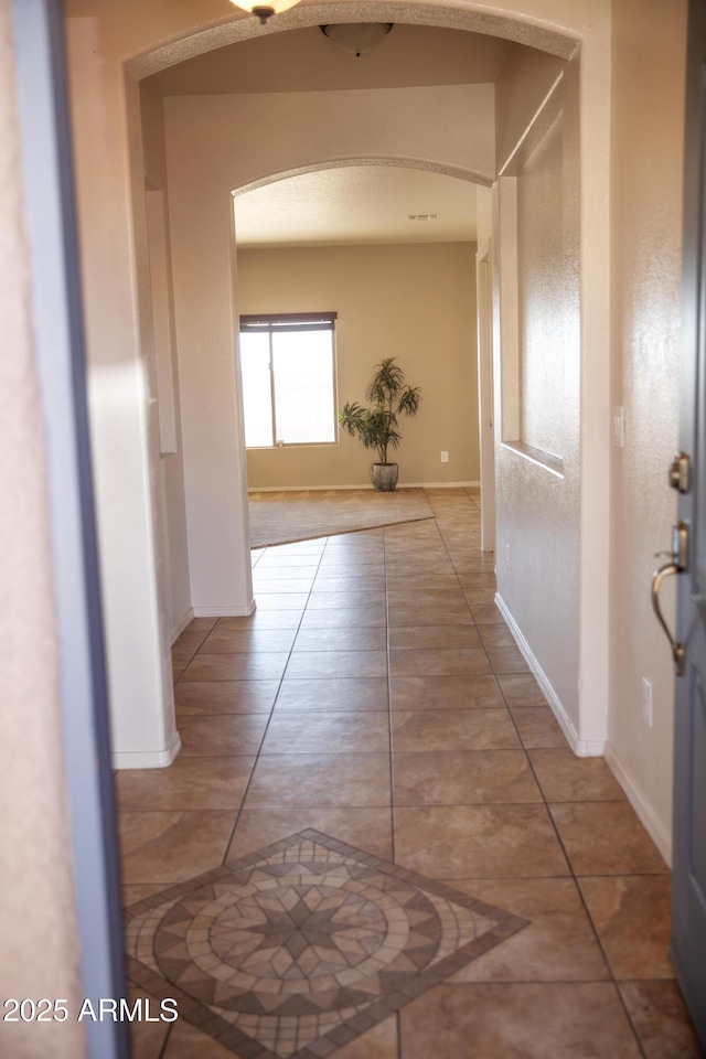 hallway with tile patterned flooring