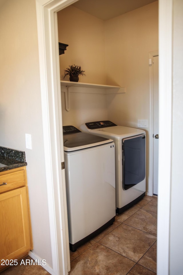 laundry room featuring tile patterned floors and washer and dryer