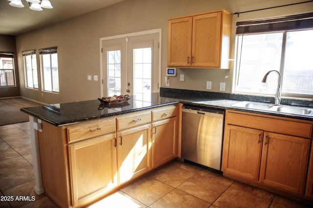 kitchen with sink, dishwasher, dark stone countertops, french doors, and kitchen peninsula