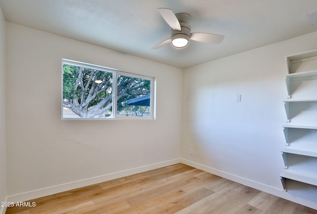 spare room featuring ceiling fan and light hardwood / wood-style flooring