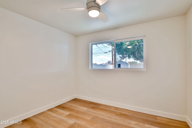 empty room featuring hardwood / wood-style flooring and ceiling fan