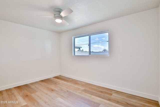 spare room featuring ceiling fan and light wood-type flooring