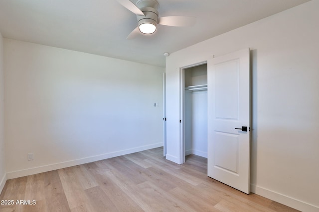 unfurnished bedroom featuring light hardwood / wood-style floors, a closet, and ceiling fan