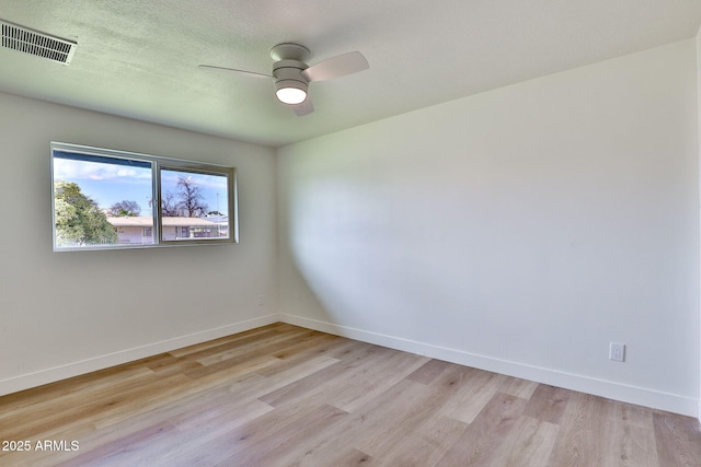 unfurnished room with ceiling fan, light hardwood / wood-style flooring, and a textured ceiling