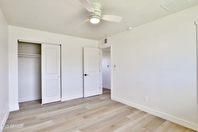 unfurnished bedroom with a closet, ceiling fan, and light wood-type flooring