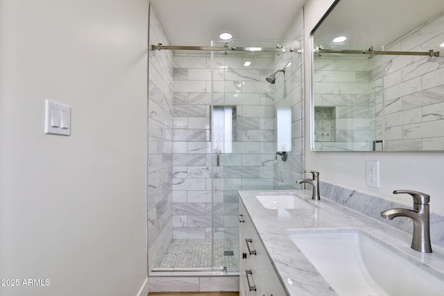 bathroom with vanity and a shower with shower door