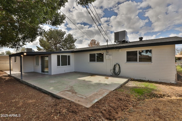 rear view of house with a patio and central air condition unit