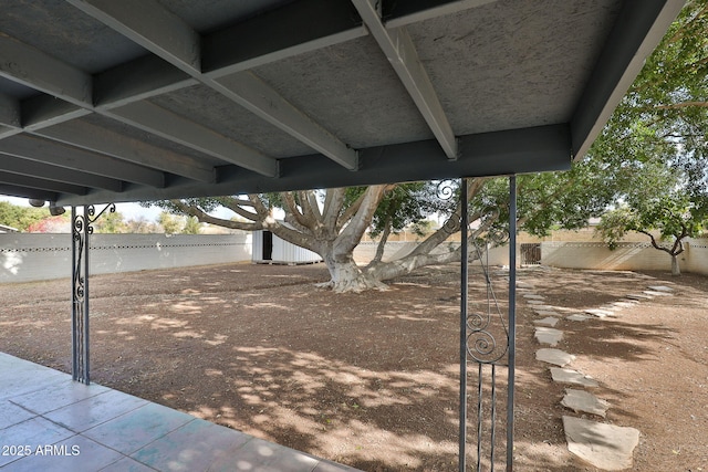 view of patio featuring a storage unit