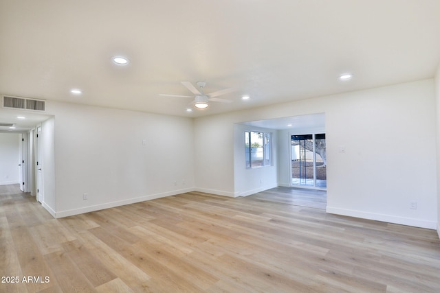 spare room featuring ceiling fan and light hardwood / wood-style floors