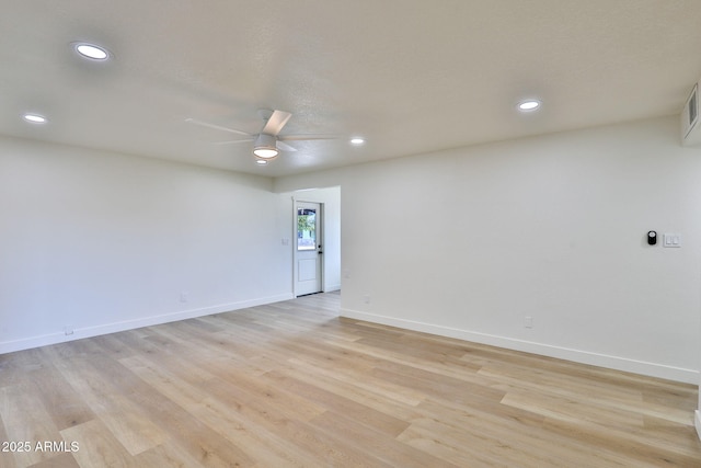 empty room featuring ceiling fan and light hardwood / wood-style floors