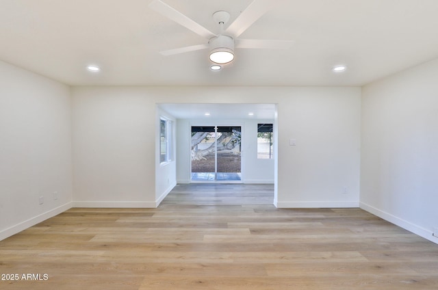 spare room with ceiling fan and light wood-type flooring