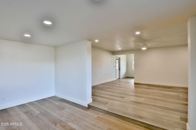 unfurnished room with ceiling fan and light wood-type flooring