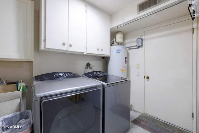 laundry area featuring cabinets, washer and clothes dryer, sink, and water heater