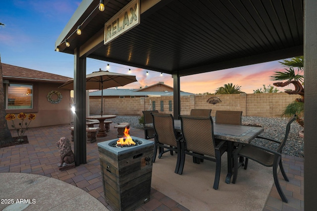 patio terrace at dusk with an outdoor fire pit