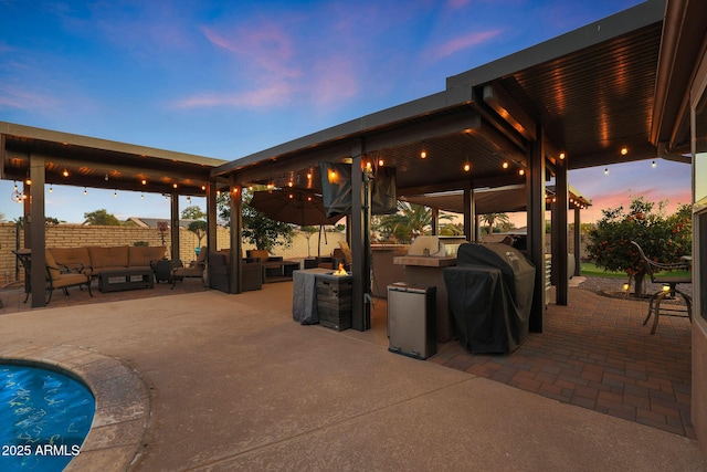 patio terrace at dusk with outdoor lounge area, a grill, and area for grilling