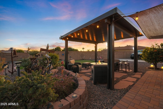 patio terrace at dusk featuring a fire pit