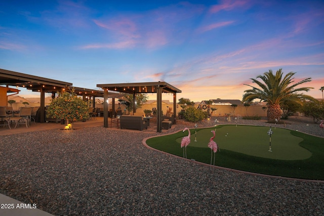 yard at dusk featuring an outdoor hangout area and a patio