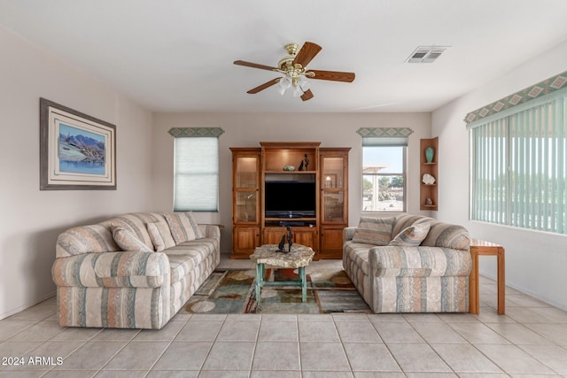 tiled living room featuring ceiling fan