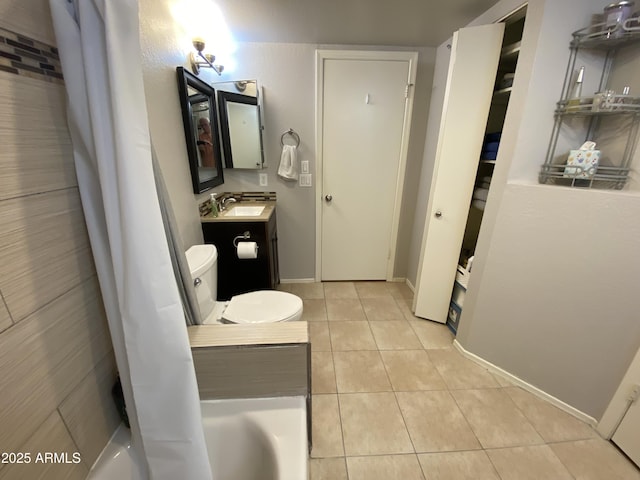 bathroom with tile patterned floors, vanity, and baseboards