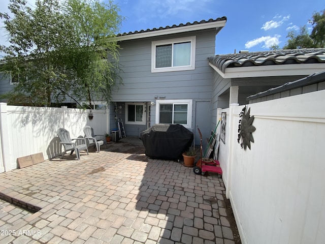back of property featuring a patio and a fenced backyard
