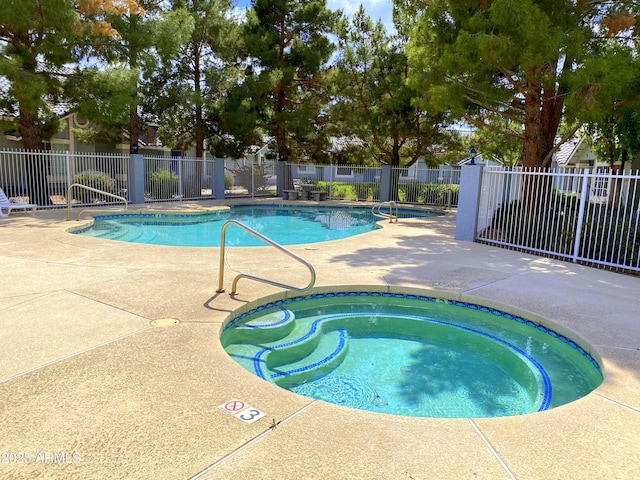 community pool featuring a community hot tub, fence, and a patio