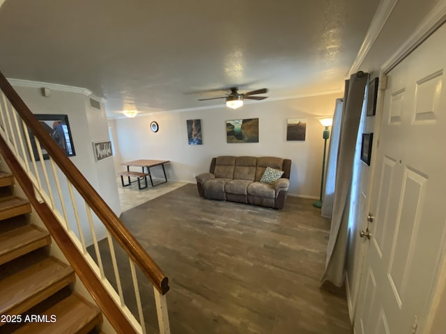 living room featuring crown molding, ceiling fan, wood finished floors, stairs, and baseboards