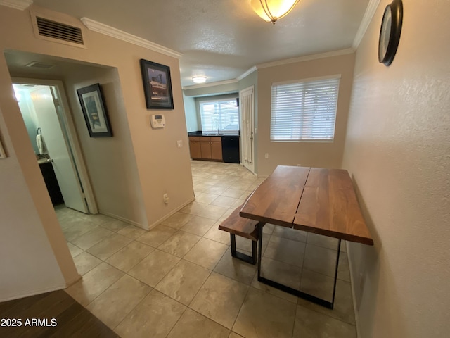 corridor with crown molding, a sink, baseboards, and light tile patterned floors