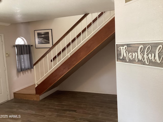 staircase with wood finished floors