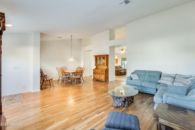 living room featuring ceiling fan and hardwood / wood-style flooring