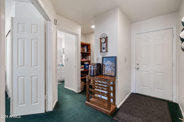 hallway with dark colored carpet