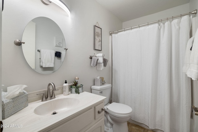 bathroom with walk in shower, vanity, and toilet