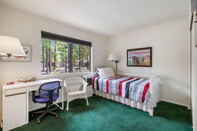 carpeted bedroom with built in desk