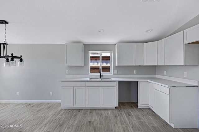 1804 E Pueblo Ave, Phoenix, AZ 85040 - kitchen featuring a sink, light wood-type flooring, light countertops, white cabinets, and lofted ceiling