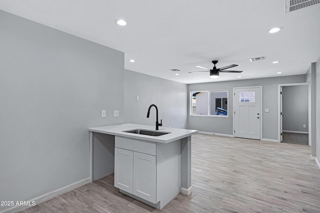 1804 E Pueblo Ave, Phoenix, AZ 85040 - kitchen featuring a sink, baseboards, ceiling fan, light wood-style flooring, and recessed lighting