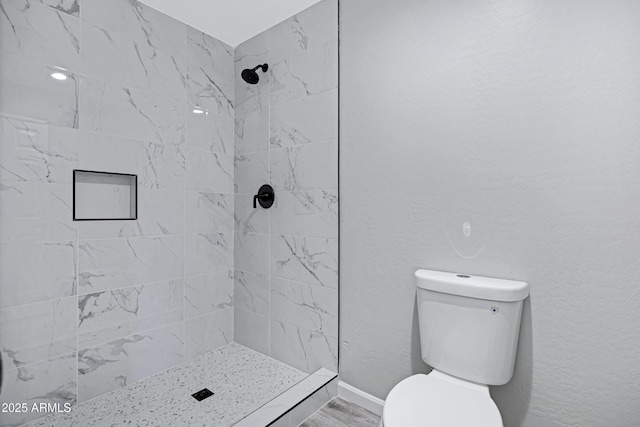 1804 E Pueblo Ave, Phoenix, AZ 85040 - bathroom with toilet, tiled shower, and wood finished floors