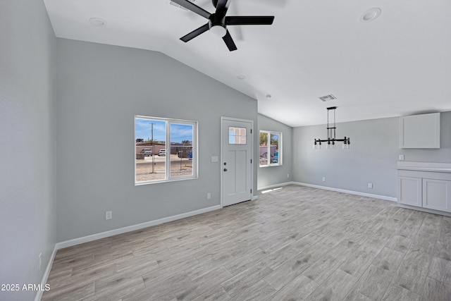 1804 E Pueblo Ave, Phoenix, AZ 85040 - unfurnished living room featuring lofted ceiling, ceiling fan, light wood-style flooring, baseboards, and a chandelier