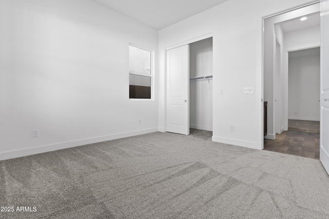 unfurnished bedroom with carpet flooring and a closet