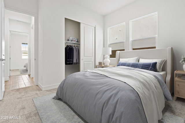 bedroom featuring light colored carpet and a closet