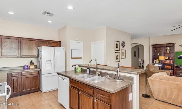 kitchen featuring a sink, white appliances, light tile patterned floors, open floor plan, and recessed lighting