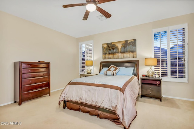 carpeted bedroom featuring baseboards and a ceiling fan