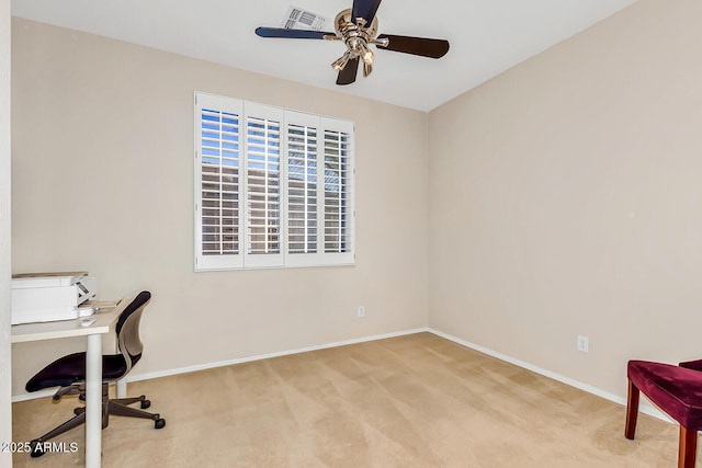 unfurnished office featuring a ceiling fan, carpet, and baseboards