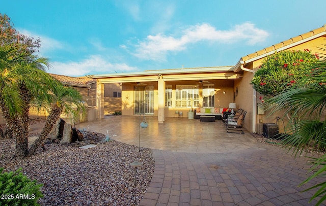 view of patio featuring a ceiling fan and an outdoor living space