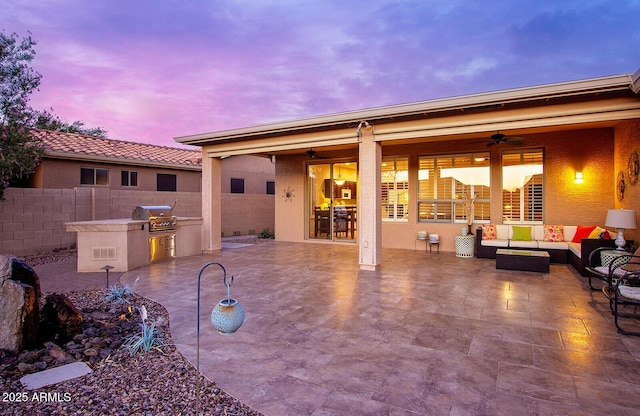 view of patio / terrace with an outdoor kitchen, a ceiling fan, fence, a grill, and an outdoor hangout area