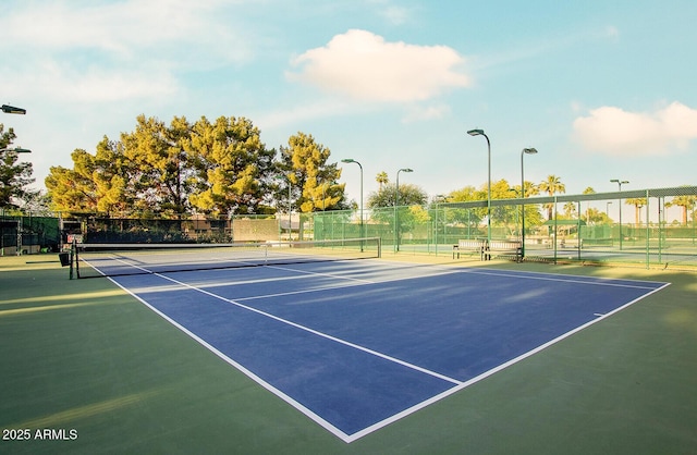 view of tennis court with fence